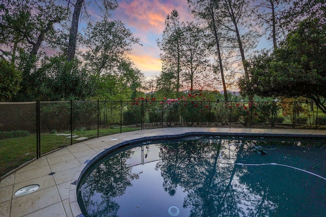 view of pool at dusk