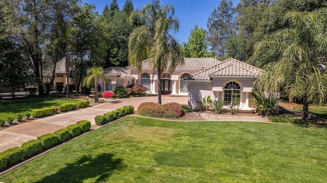 mediterranean / spanish-style home featuring a front yard