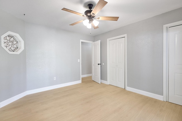 unfurnished bedroom with ceiling fan and light hardwood / wood-style flooring