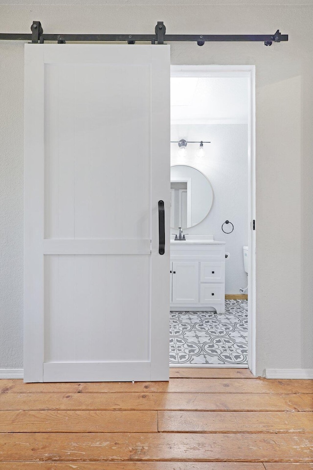 bathroom with hardwood / wood-style flooring, vanity, and toilet