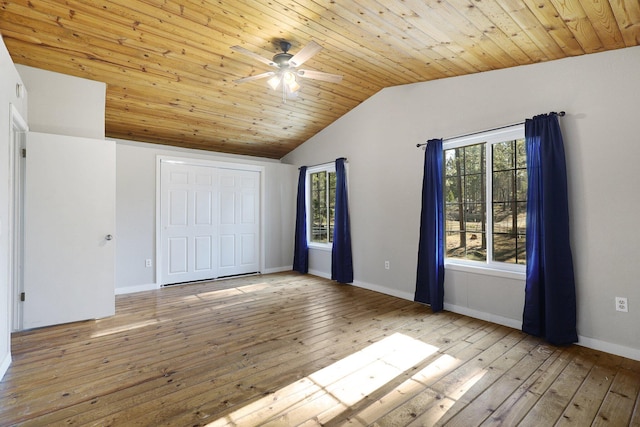 unfurnished bedroom featuring lofted ceiling, wood ceiling, a closet, ceiling fan, and light hardwood / wood-style floors