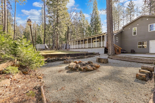 view of yard featuring a patio area, a fire pit, and a sunroom