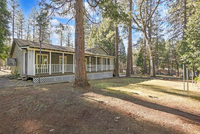 view of front of house with a porch and a front yard