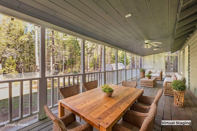 sunroom / solarium featuring plenty of natural light, wooden ceiling, and ceiling fan