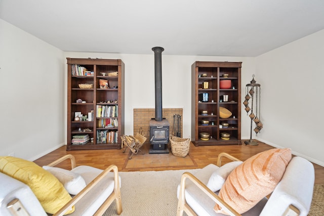 living room featuring hardwood / wood-style floors and a wood stove