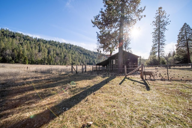 view of yard featuring an outbuilding and a rural view