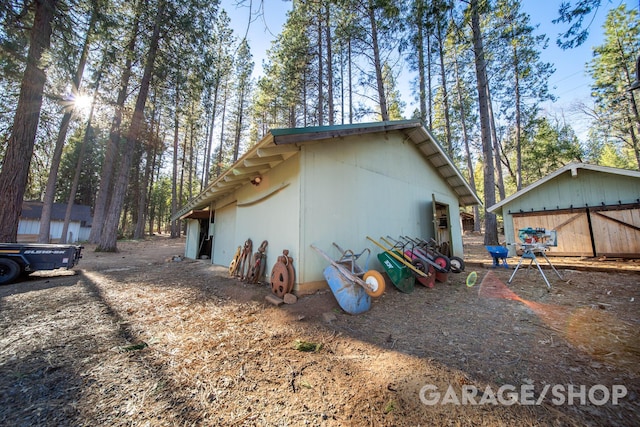 view of home's exterior featuring a garage and an outdoor structure