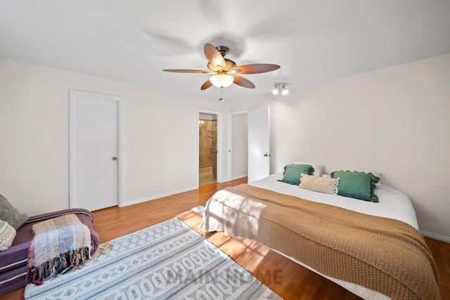 bedroom featuring hardwood / wood-style floors and ceiling fan