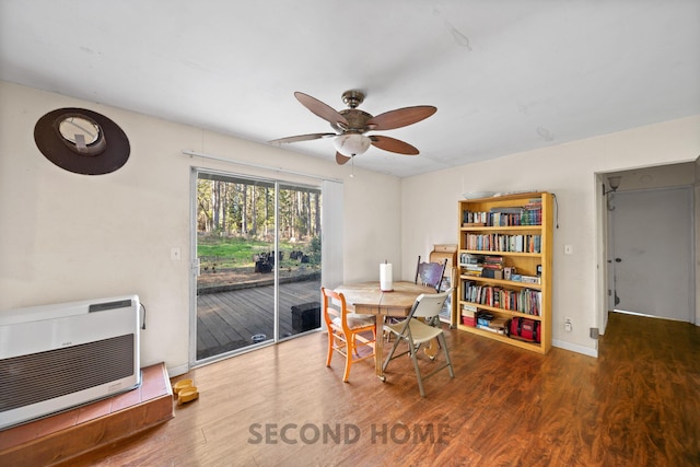 dining area with heating unit, hardwood / wood-style floors, and ceiling fan