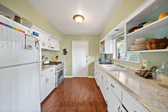 kitchen featuring sink, white cabinets, dark hardwood / wood-style flooring, white fridge, and high end stainless steel range