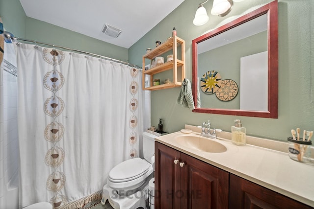 bathroom featuring vanity, toilet, and curtained shower