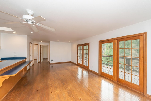 spare room with ceiling fan, french doors, and light wood-type flooring