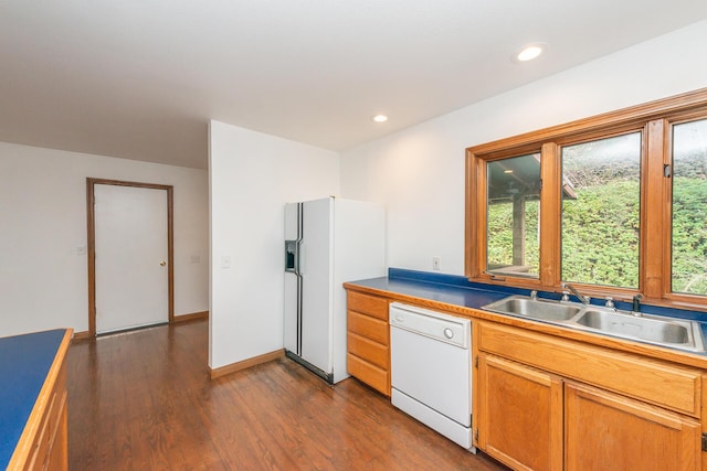 kitchen with dark wood-type flooring, sink, and white appliances