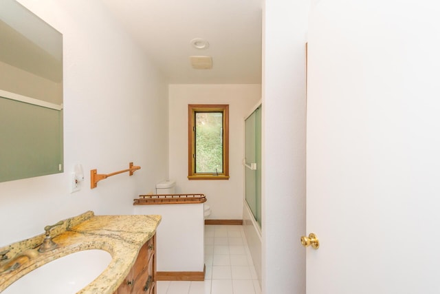 full bathroom featuring toilet, bath / shower combo with glass door, tile patterned flooring, and vanity