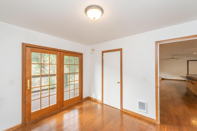 unfurnished room with ceiling fan and hardwood / wood-style floors