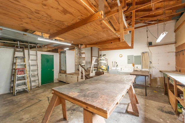 basement with electric panel, independent washer and dryer, and a workshop area