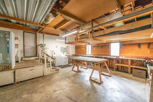 basement featuring washer / clothes dryer, electric panel, and a workshop area