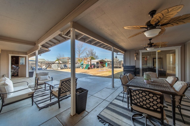 view of patio / terrace featuring a residential view, fence, an outdoor living space, a playground, and outdoor dining space