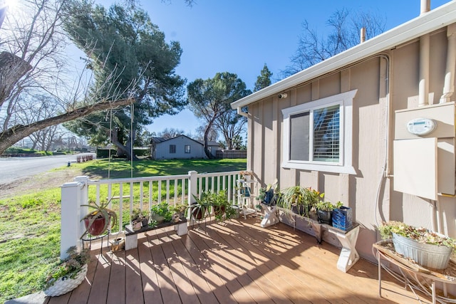 wooden terrace with a yard