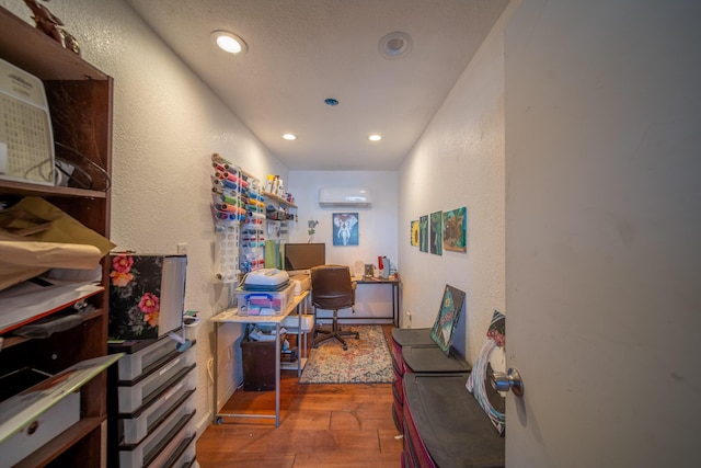 office area with hardwood / wood-style floors and a wall unit AC