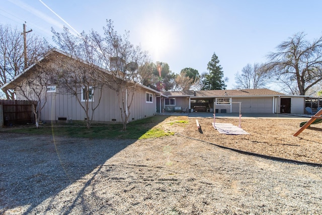 view of front of home with a carport and a garage