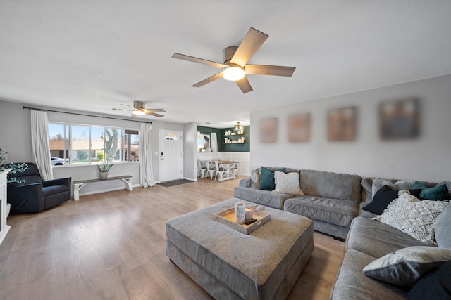 living room with wood-type flooring and ceiling fan