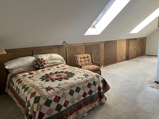 bedroom featuring carpet flooring, wooden walls, and vaulted ceiling with skylight