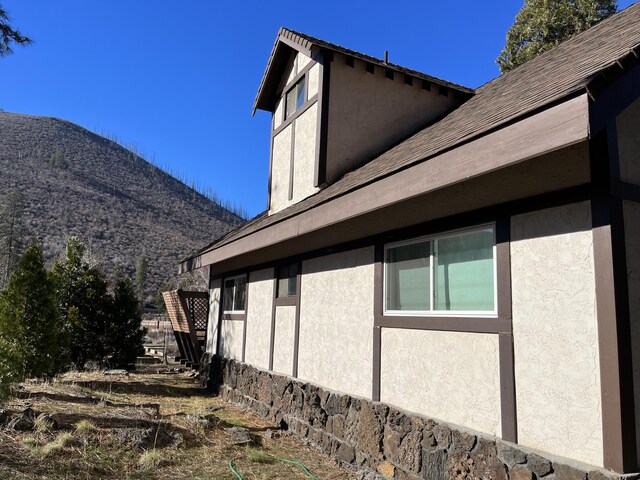 view of property exterior featuring a mountain view