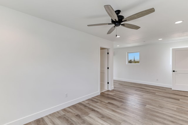 unfurnished room with ceiling fan and light wood-type flooring