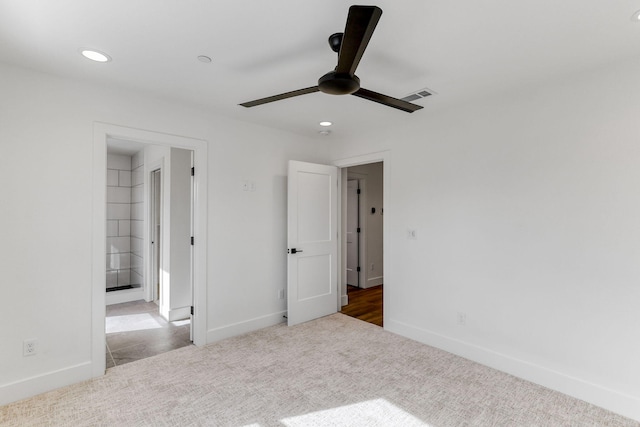 unfurnished bedroom with ceiling fan and light colored carpet