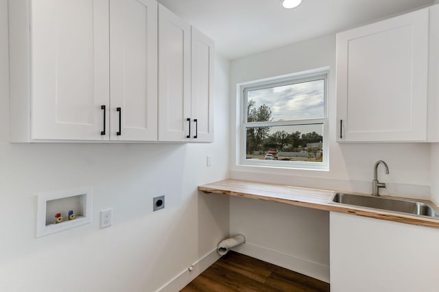 washroom with sink, cabinets, washer hookup, dark wood-type flooring, and hookup for an electric dryer