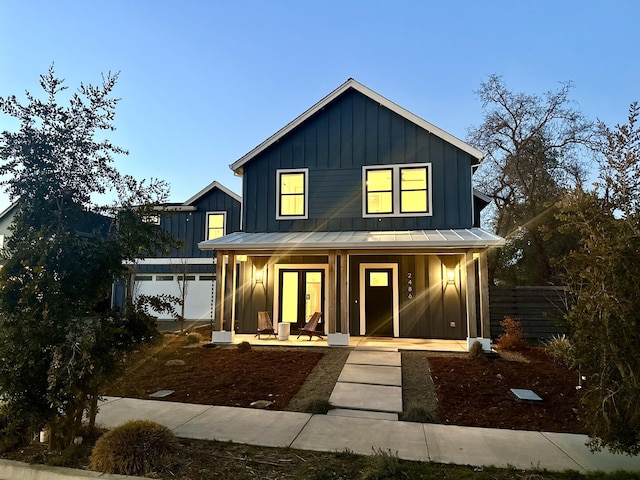 modern farmhouse style home featuring covered porch