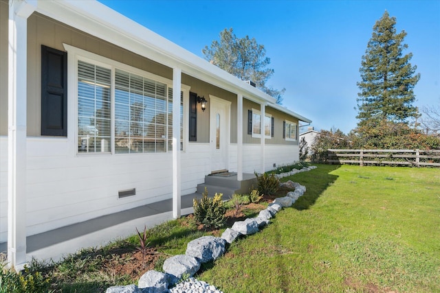 view of side of property featuring a yard