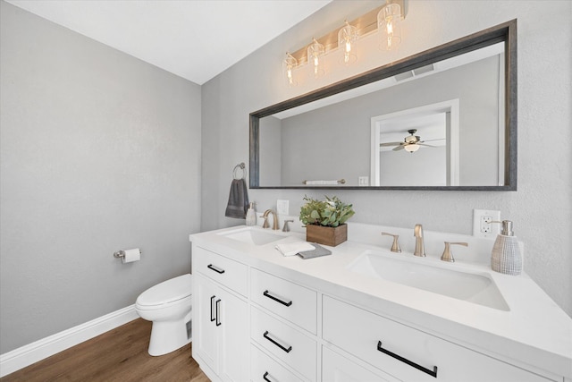 bathroom with hardwood / wood-style flooring, vanity, and toilet