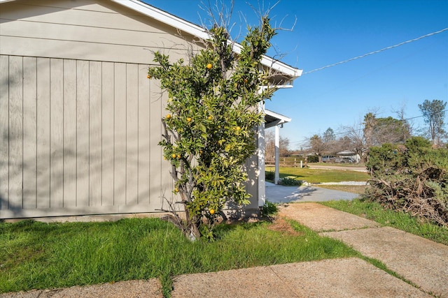 view of side of home featuring a lawn