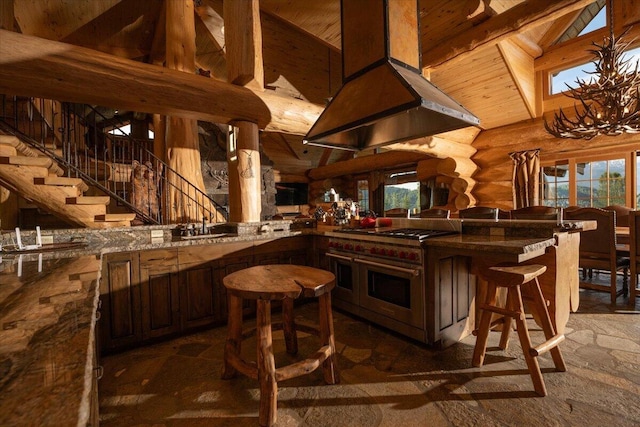 bar with lofted ceiling with beams, rustic walls, range with two ovens, ventilation hood, and wooden ceiling