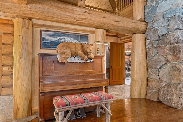 miscellaneous room featuring hardwood / wood-style flooring, beam ceiling, and log walls