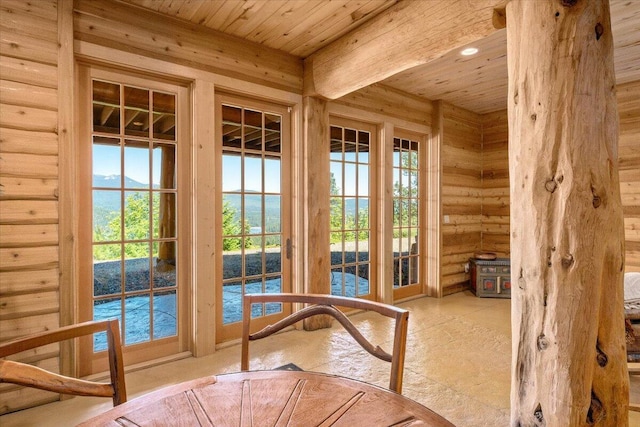 doorway to outside with wooden ceiling and log walls