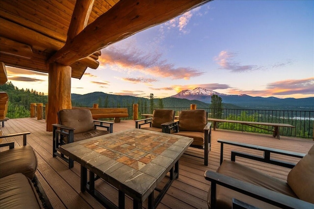 deck at dusk featuring outdoor lounge area and a mountain view