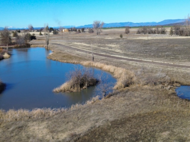 view of water feature with a rural view and a mountain view