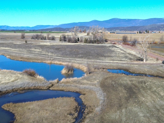 property view of mountains with a water view and a rural view