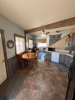 dining space with ceiling fan and lofted ceiling with beams