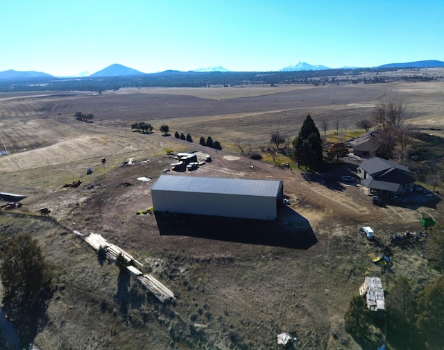 birds eye view of property with a mountain view and a rural view