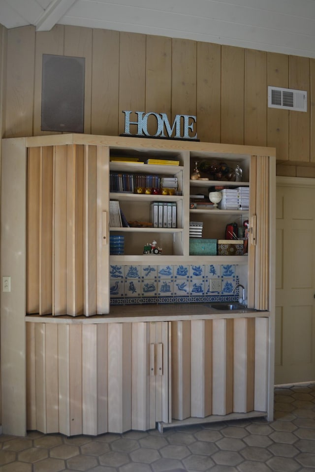 room details featuring wood walls and sink