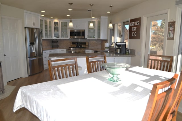 dining area with dark hardwood / wood-style flooring and sink