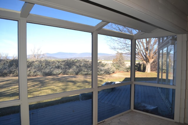 unfurnished sunroom featuring a mountain view