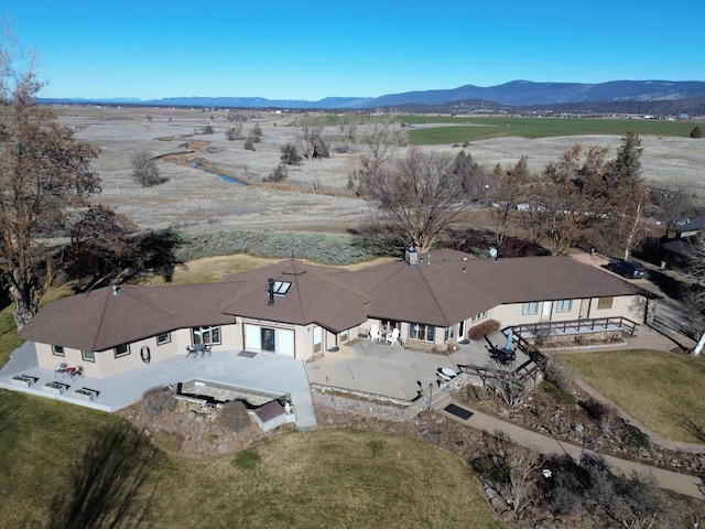 birds eye view of property featuring a mountain view