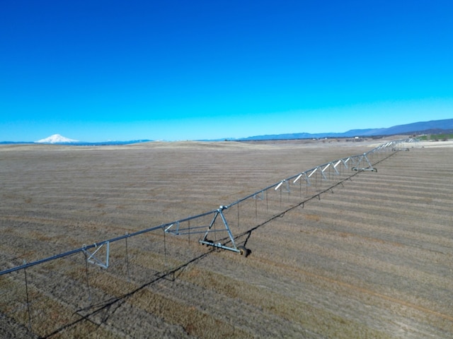 drone / aerial view featuring a mountain view and a rural view