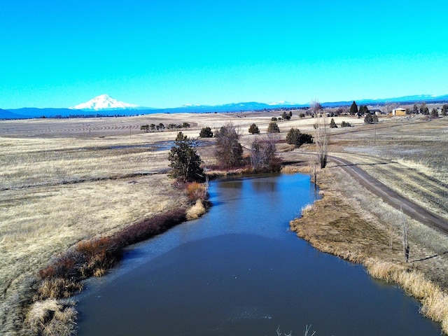 bird's eye view featuring a water and mountain view and a rural view