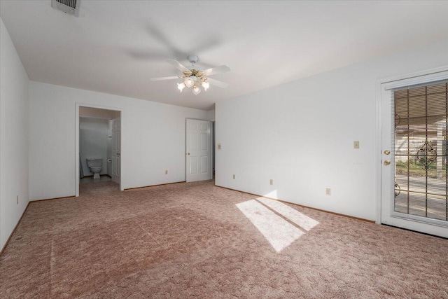 interior space featuring ceiling fan, carpet flooring, access to exterior, and ensuite bath